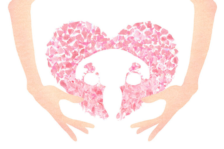 両手で包み込む形で描かれた、子宮をイメージしたピンク色のハートのイラスト